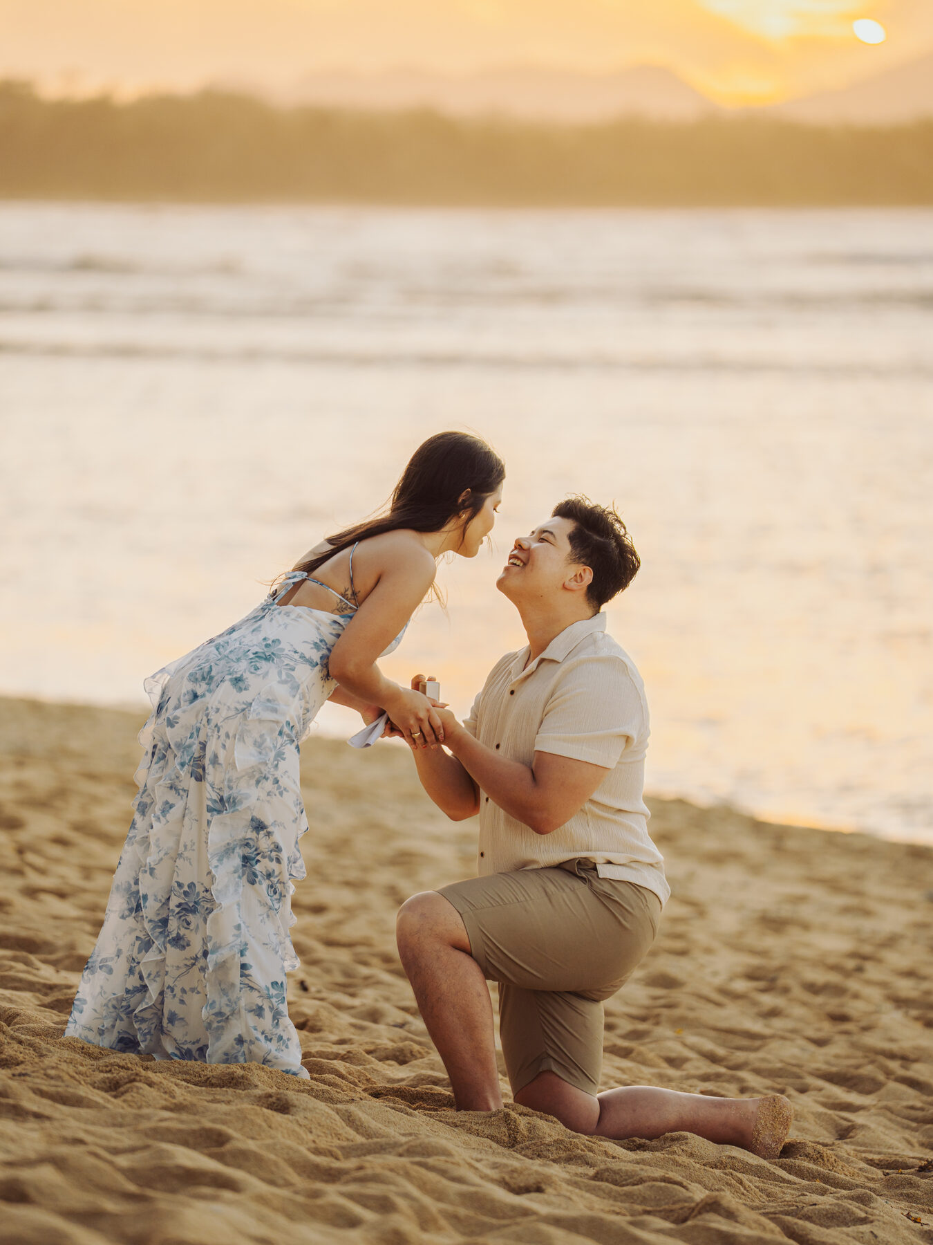 Anthony on one knee, proposing to Angela on a beach in Siargao, Philippines.