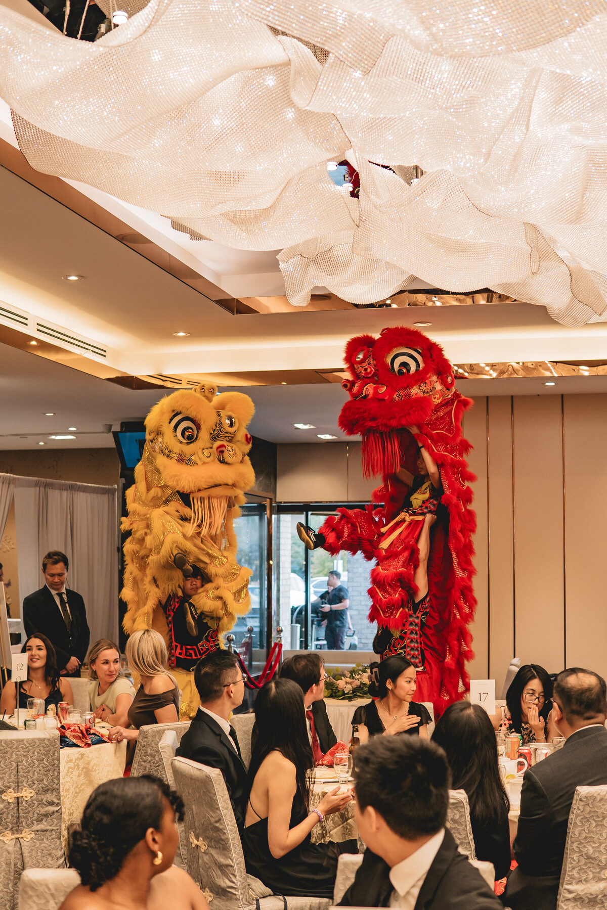 Lion dance performers weaving through guests at Peter & Christine's reception.