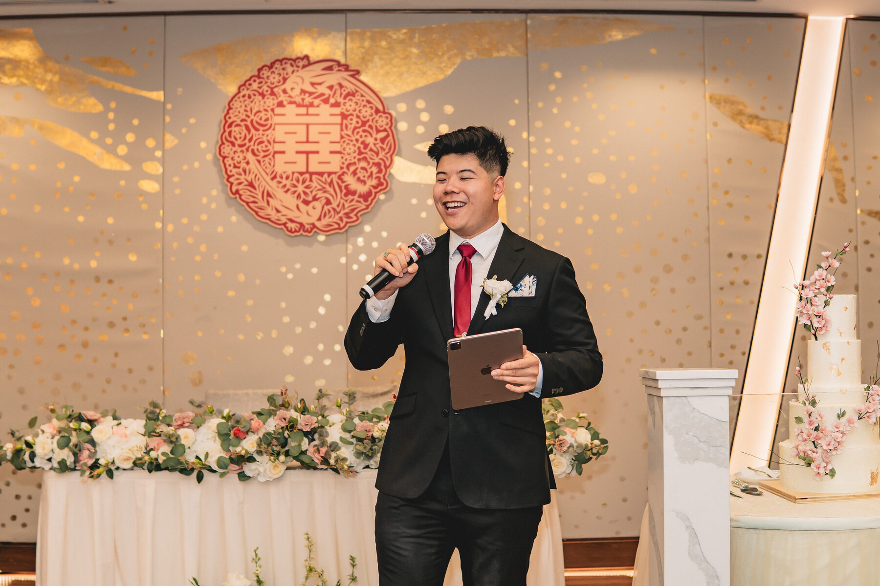 Anthony hosting near the cake table at Peter & Christine's reception.