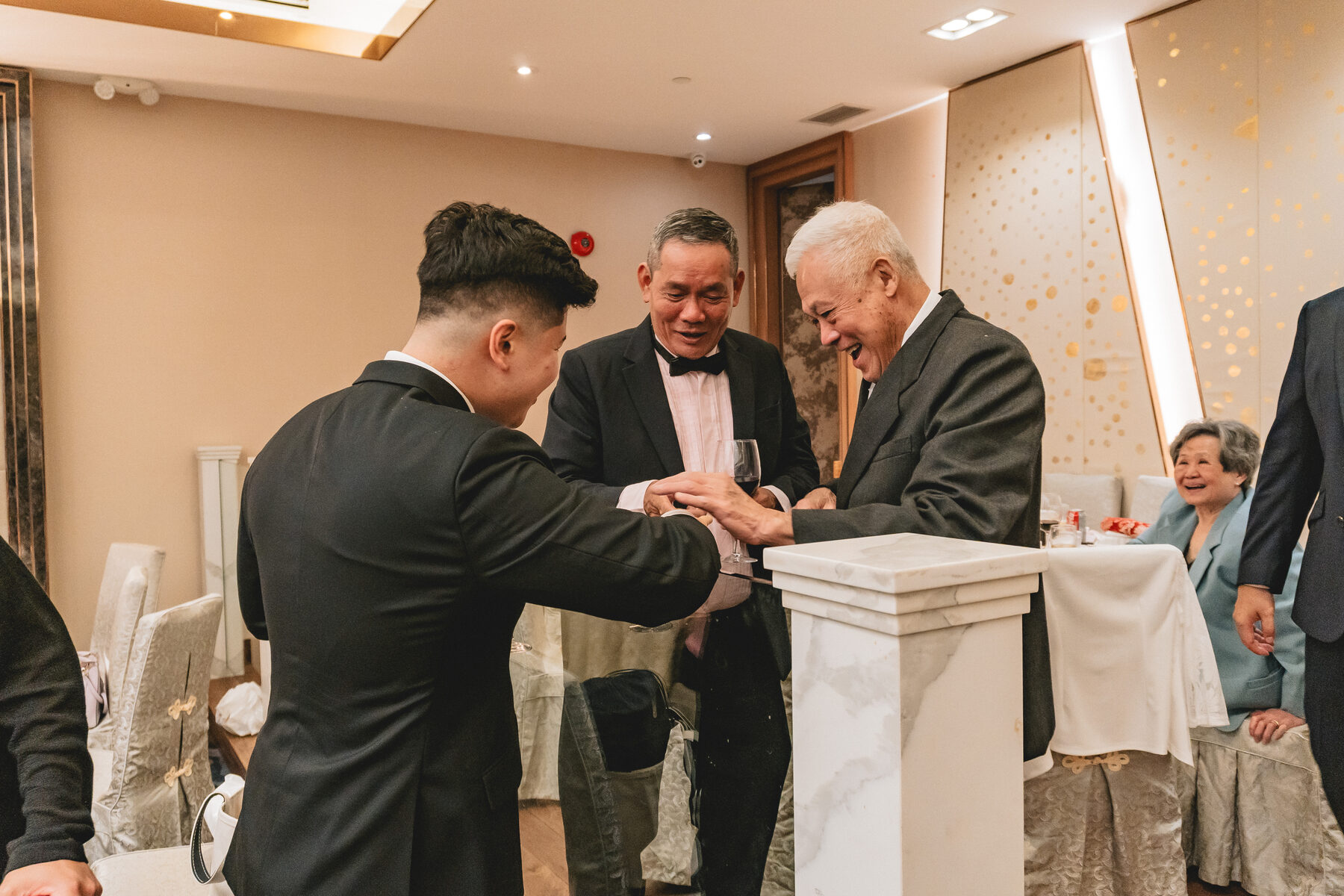 Anthony sharing a toast with a guest at Peter & Christine's reception.