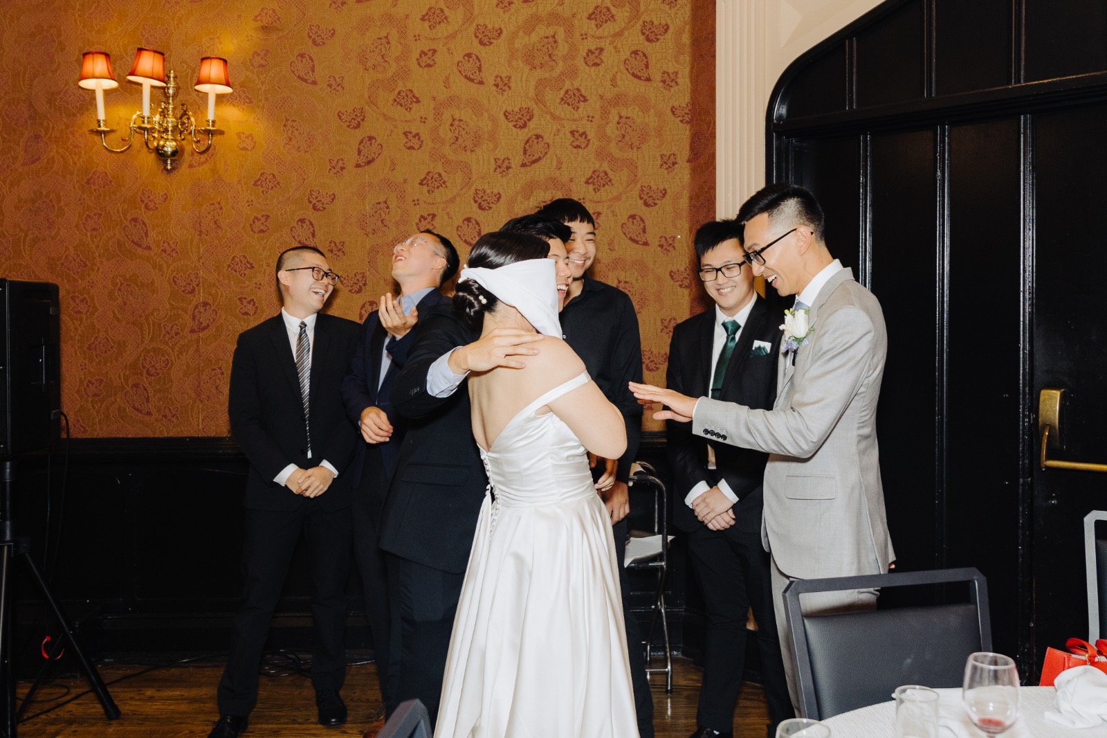 Guests gathered around, laughing, during Steven & Esther's reception.