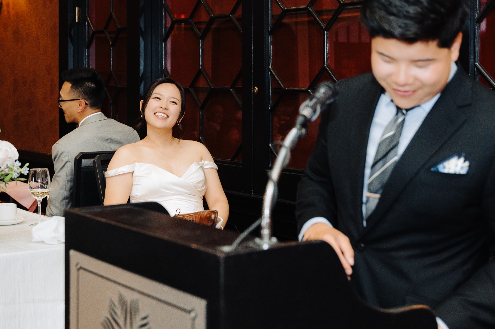 Anthony speaking at the podium during speeches at Steven & Esther's Toronto reception.