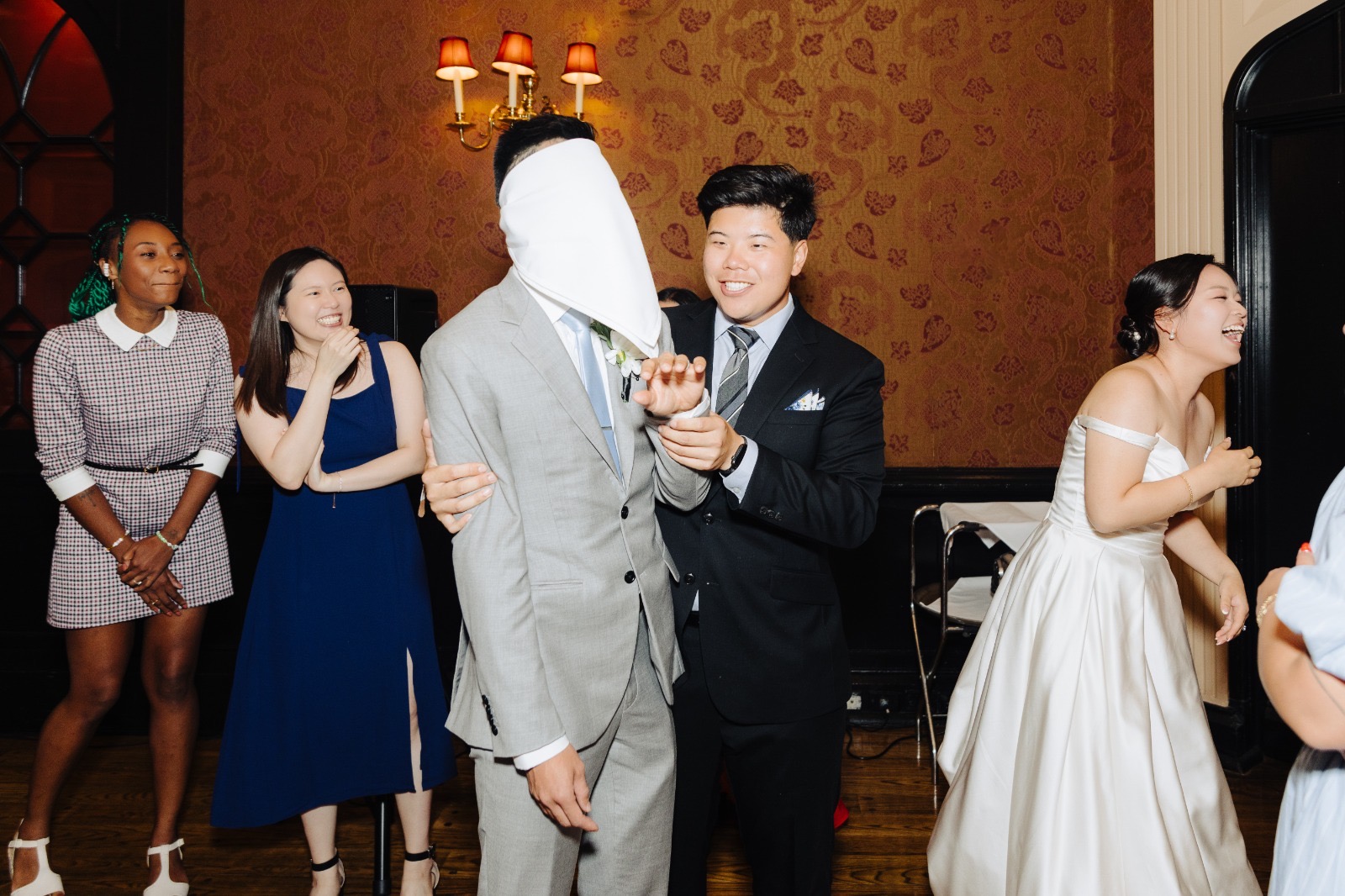 A playful reception game moment at Steven & Esther's wedding.